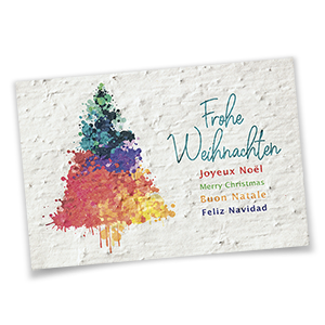 Vergrößere Abbildung Nachhaltige Weihnachtskarte aus Samenpapier mit buntem Baum und Weihnachtsgrüßen in fünf Sprachen.